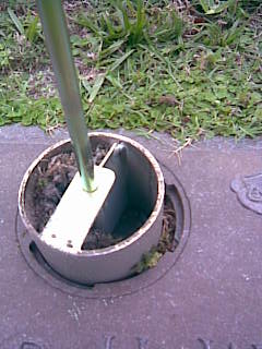 Turn the drill on and the Cemetery Vase Clean Out Tool removed the debris