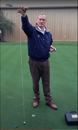 Next, put the six foot measuring chain of the Precision Putting Green Firmness Compaction Meter on your ring or middle finger and extend your are so the tip of the measuring chain's weight lightly touches the putting green's surface