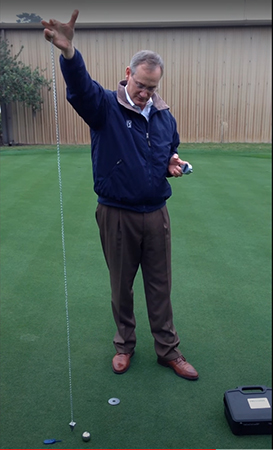Next, hold the bearing ball in the same hand as the measuring chain on the Precision Putting Green Firmness Compaction Meter, drop it from six feet. Note the ball should be level with the top of the ring at release