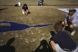 STMA Field Maintenance seminar, North High School, Phoenix.  Abby McNeal, M.J. Calvert and Ross Kurcab, from the Denver Bronco's filling in the lines left by the stencil.
