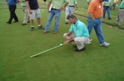 Here is John Foy, Southeastern agronomist for the USGA showing me how to properly use the Stimp Meter.  John was an attendee at the field day but I had to get this photo.