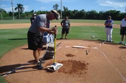 This is Ken Czerniak demonstrating the correct way to fix holes in the pitchers mound after a game.