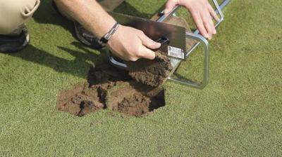Scraping bottom of plug flat on 9 Inch Hexagon Turf Plugger with trowel provided with unit insures even insertion of plugs and prevents scalping